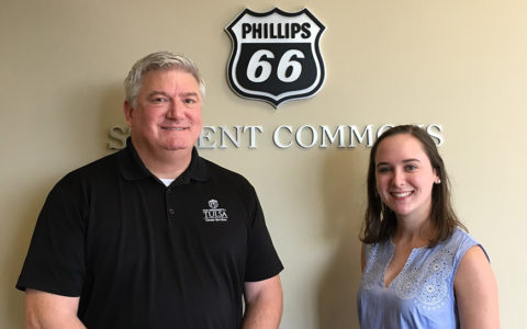 A student smiles with a career services adviser
