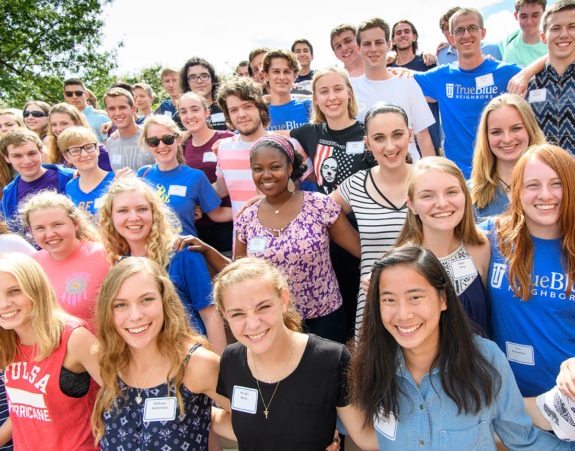 honors students stand smiling arm in arm