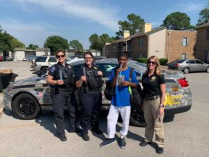 Murphy with fellow Tulsa officers passing out school supplies. 