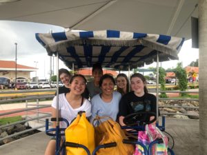 Julianne Tran and friends in an open-sided motorized vehicle in Panama