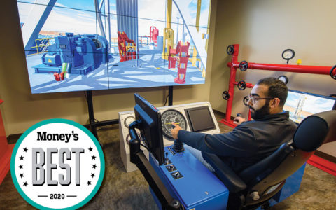 young man sitting at the controls of an engineering simulation machine