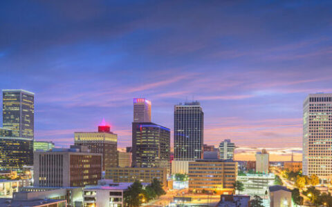 a colorful evening scene of downtown Tulsa buildings