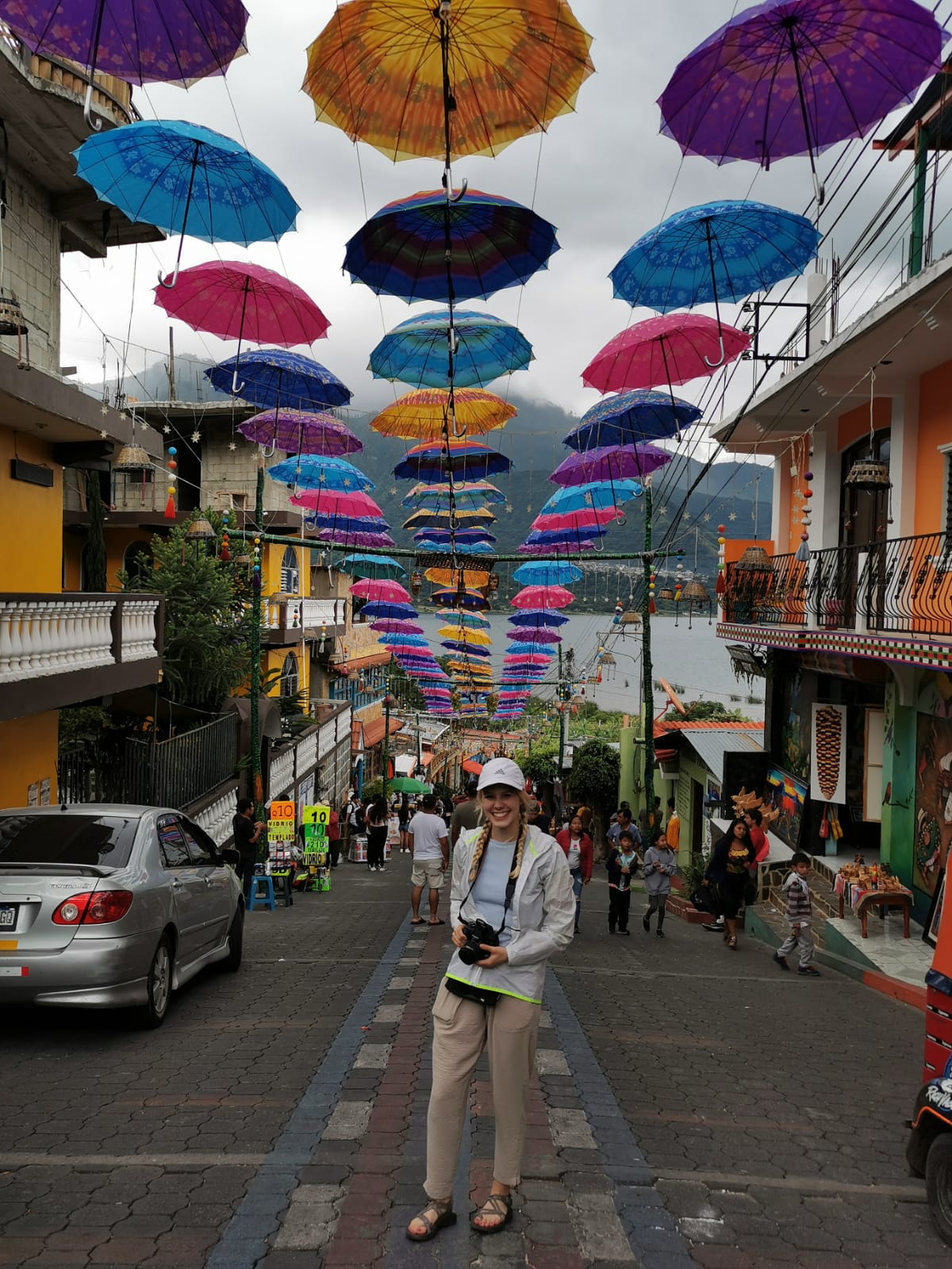 Person with camera on a cobblestone street