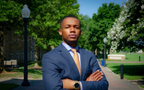 law student posing outside with arms crossed