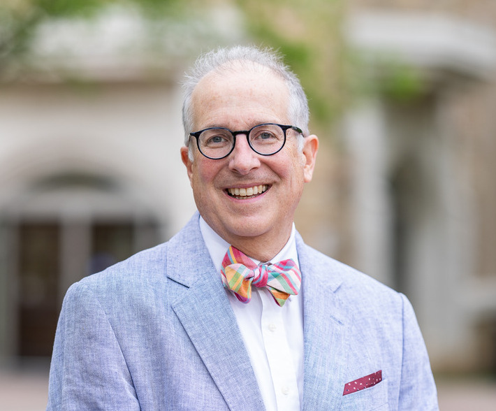 George Justice, Ph.D., wearing a colorful bow tie and glasses.