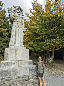 woman standing next to a large statue outdoors