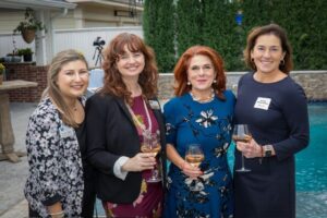 four women in front of pool