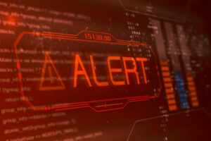 The word ALERT in capital letters set in red against a computer screen