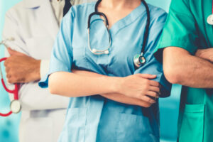 close-up shot of three people in hospital scrubs with arms crossed
