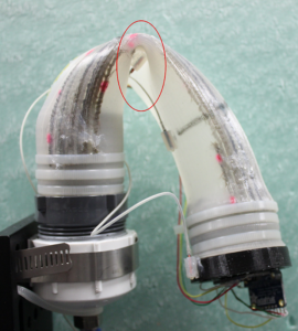 a small soft robot bent forward in the middle
