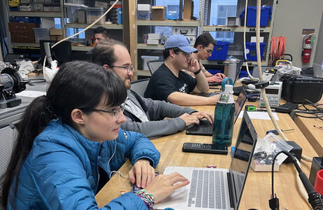 Students working on laptops in an ECE lab.