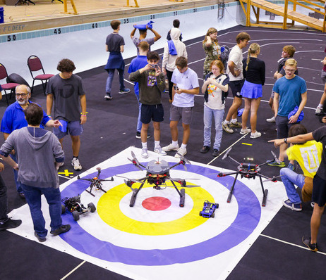 Photograph of students working in TU's drone lab.