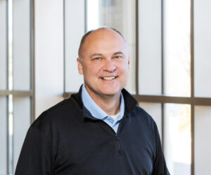 Portrait of Justin Miller, M.A., M.S., smiling indoors