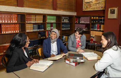 law students sitting in library with books