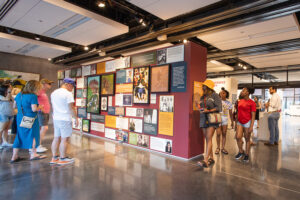 Photograph of visitors engaging with Oklahoma Center for the Humanitites exhibition displays.
