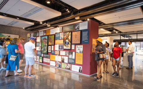 Photograph of visitors engaging with Oklahoma Center for the Humanitites exhibition displays.