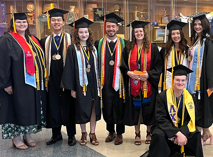 Happy UTulsa Honors students smiling at commencement