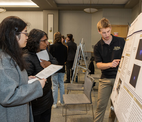 Photograph of UTulsa faculty and students engaging during a graduate seminar presentation