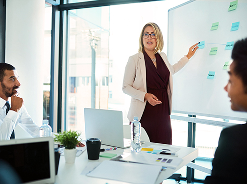 Photograph of a person leading a brainstorming session in a professional setting