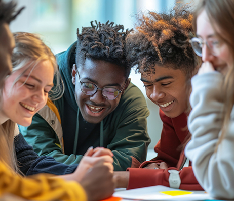 Photograph of students laughing while discussing a book