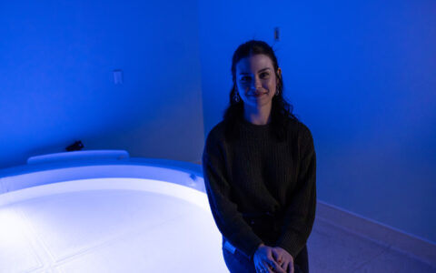 Rachel Thompson sitting and smiling in a lit room at LIBR