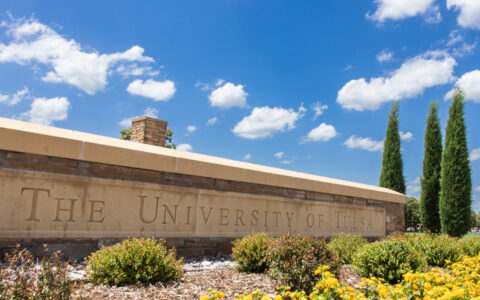 Photo of a concrete and brick sign that reads The University of Tulsa