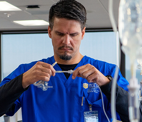 Photograph of a nurse preparing an I.V.