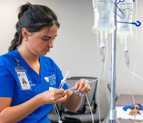 Photograph of a nurse preparing an I.V.