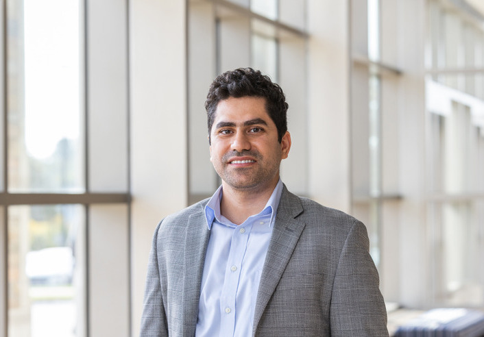 Portrait of professor with NSF grant for AI and solar power integration.