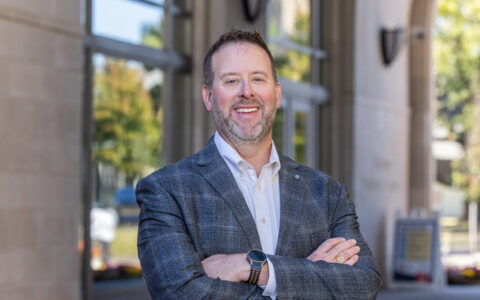 Walker, the new dean of UTulsa's Oxley College of Health & Natural Sciences, smiles outdoors.