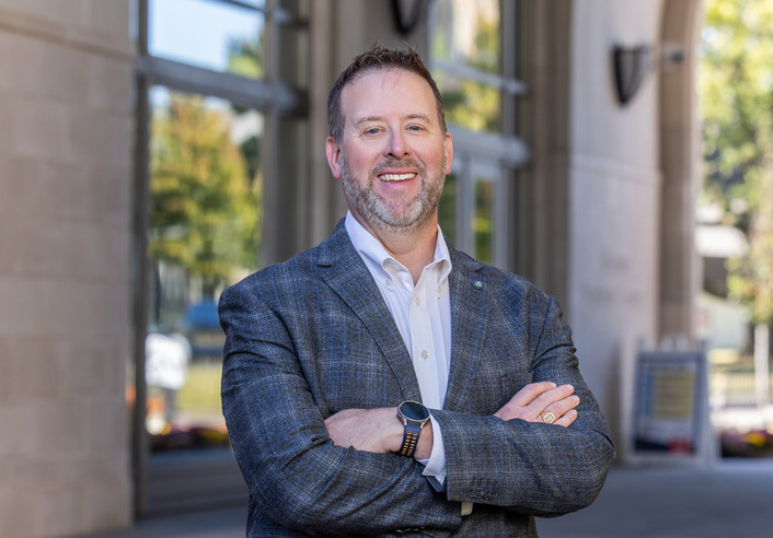 Walker, the new dean of UTulsa's Oxley College of Health & Natural Sciences, smiles outdoors.