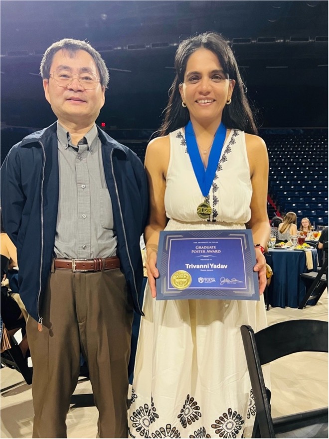 Trivanni Yadav, UTulsa physics doctoral student, receives a Graduate Poster Award with a professor.