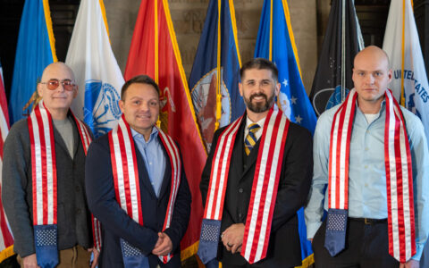 UTulsa student veterans pose with American flag stoles