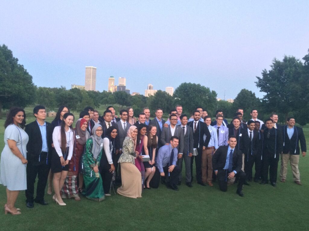 Group photo of petroleum engineering students with the Tulsa skyline.