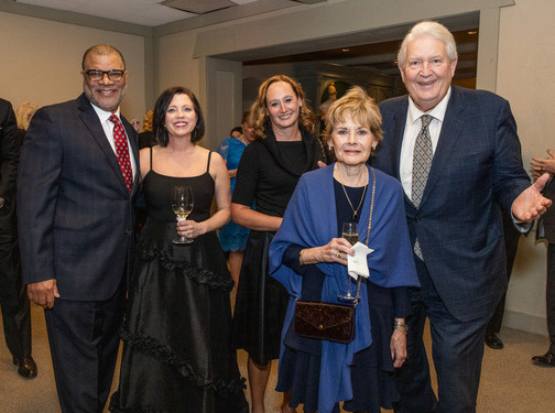 Attendees at a law alumni gala posing for a photo.
