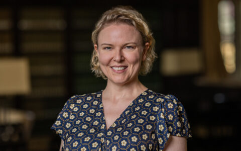 UTulsa communication sciences professor smiles in patterned blouse.