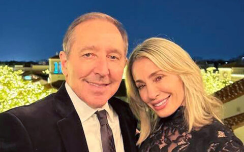 Paul and Kara Coury at an event, smiling for a photo.