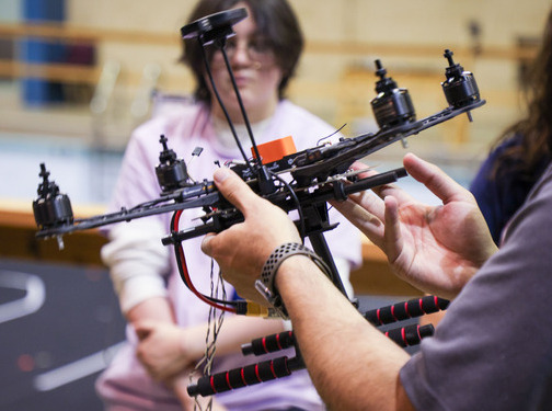 Hands holding a drone at The University of Tulsa.