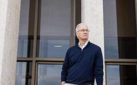 Civil rights litigator standing in front of UTulsa Law building.