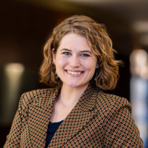 Margie Tanner in patterned blazer, professional headshot. 