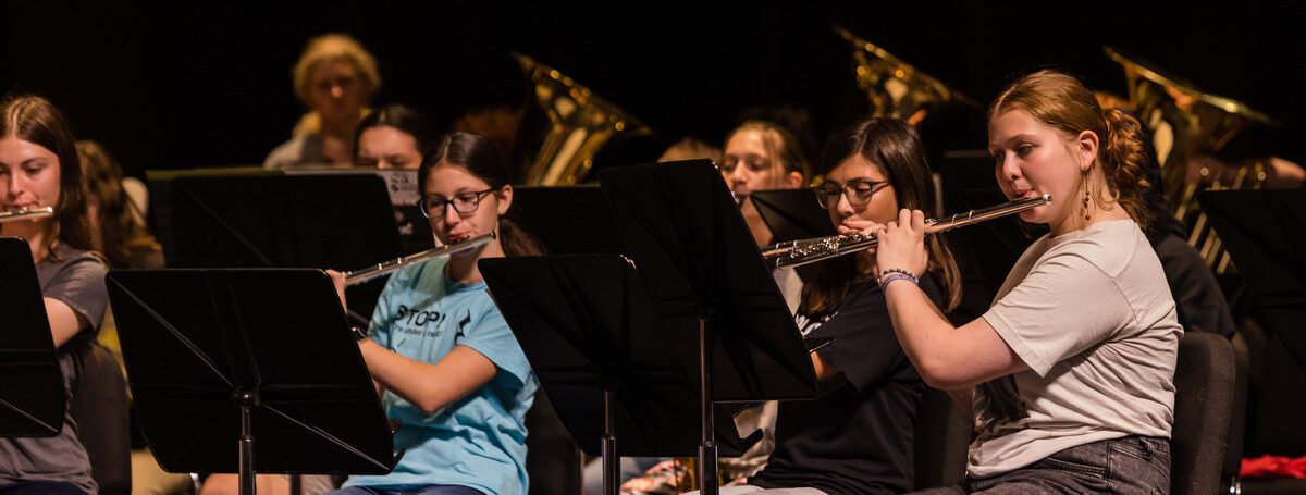 Flute section at band camp rehearsal, students playing.