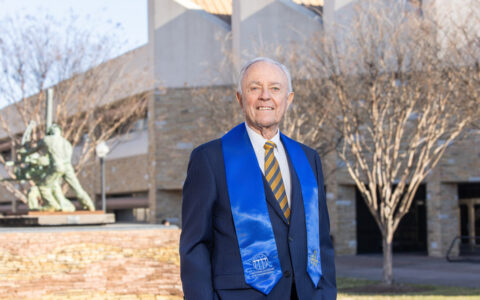 NAE member in blue sash at UTulsa event, subsurface engineering focus.