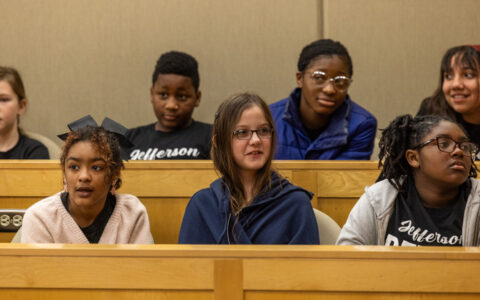 Elementary students in a mock trial at Kendall Court, some wearing Jefferson shirts.