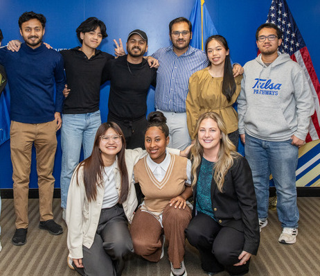 Diverse group photo at a Global Engagement event with flags.