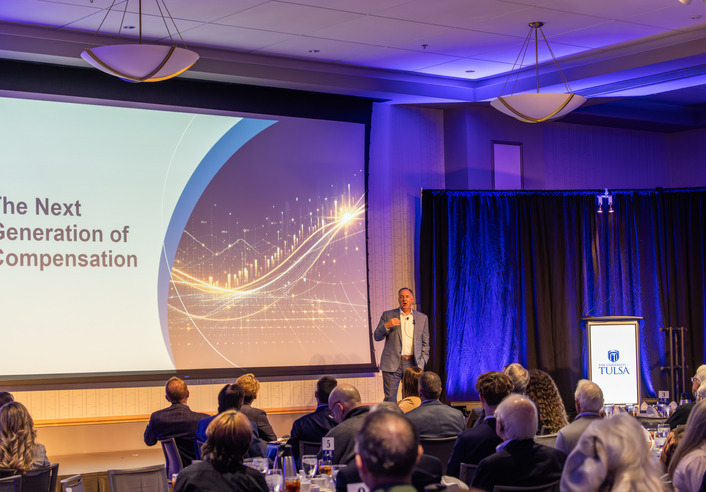 Chris Crawford presenting "The Next Generation of Compensation" at Friends of Finance event.