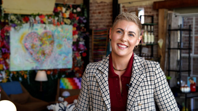 Photograph of Kristin Robert, owner of The Bend Mercantile, inside the store.