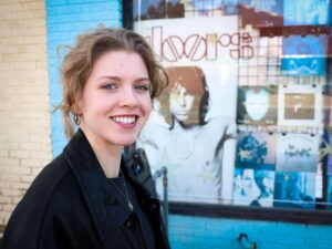 Photograph of Emma Dixon. The Doors poster visible.