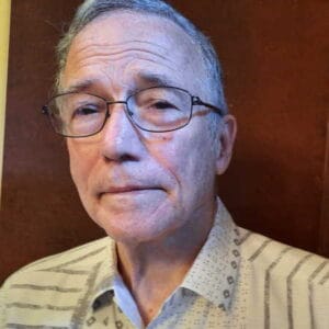 Portrait of man with glasses, likely faculty at McDougall School of Petroleum Engineering.