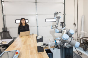 UTulsa student works with a robot on a research project