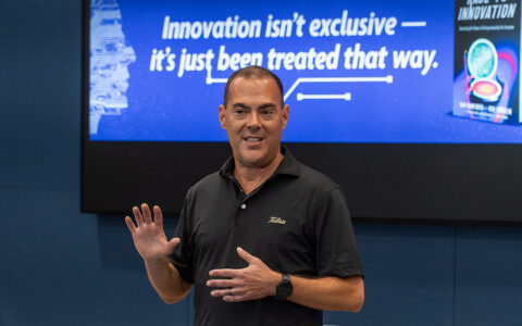 Man presenting at UTulsa Hurricane Ventures event. Text: "Innovation isn't exclusive